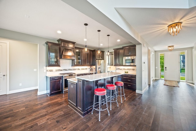 kitchen with dark brown cabinets, stainless steel appliances, light countertops, and custom range hood