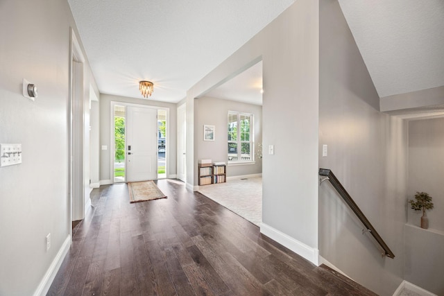 foyer entrance featuring baseboards and wood finished floors