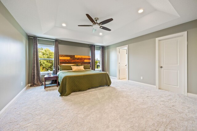 bedroom with carpet, baseboards, recessed lighting, ceiling fan, and a raised ceiling