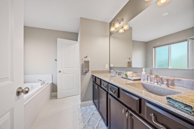 full bath with a sink, tiled bath, double vanity, and tile patterned flooring