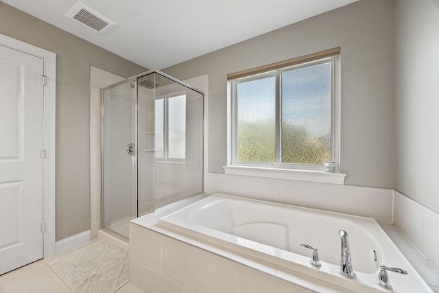 full bath with visible vents, a bath, a shower stall, and tile patterned flooring