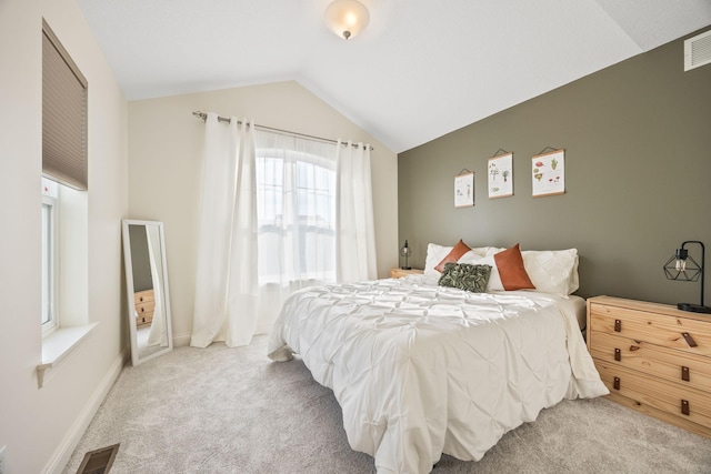 bedroom with visible vents, baseboards, lofted ceiling, and carpet floors