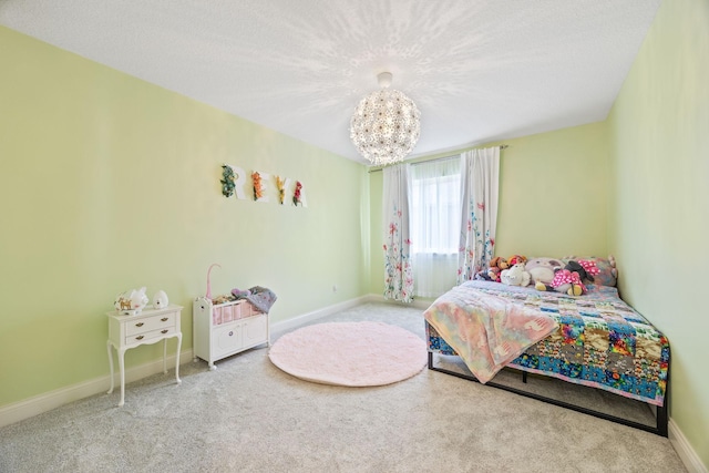 bedroom featuring a textured ceiling, carpet, baseboards, and a chandelier