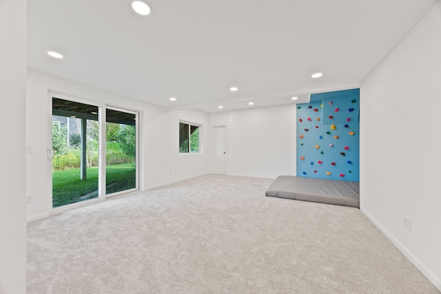 carpeted spare room with recessed lighting and baseboards