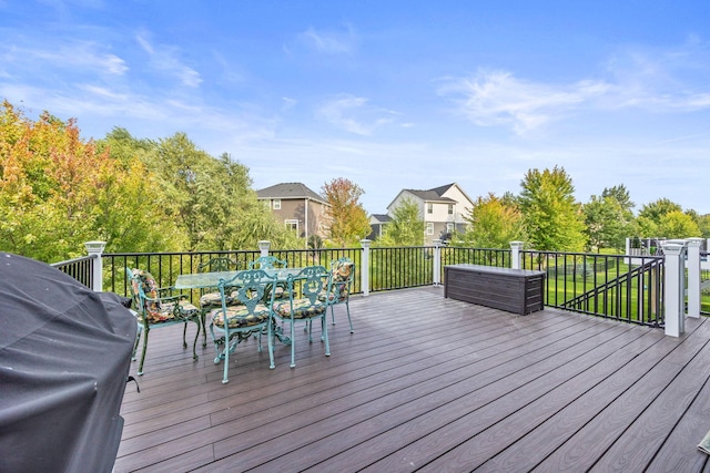 deck featuring a grill and outdoor dining space