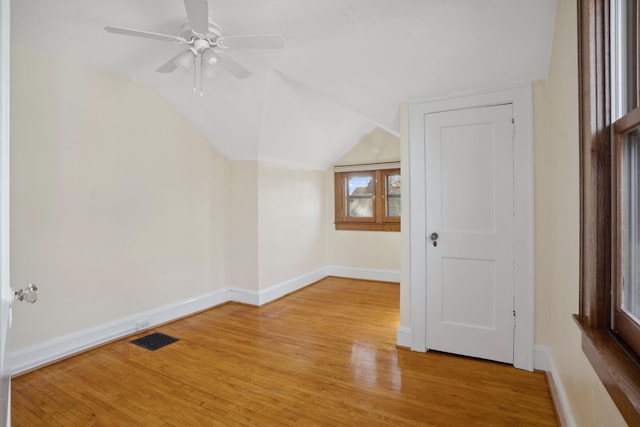 bonus room with visible vents, lofted ceiling, light wood-type flooring, and baseboards