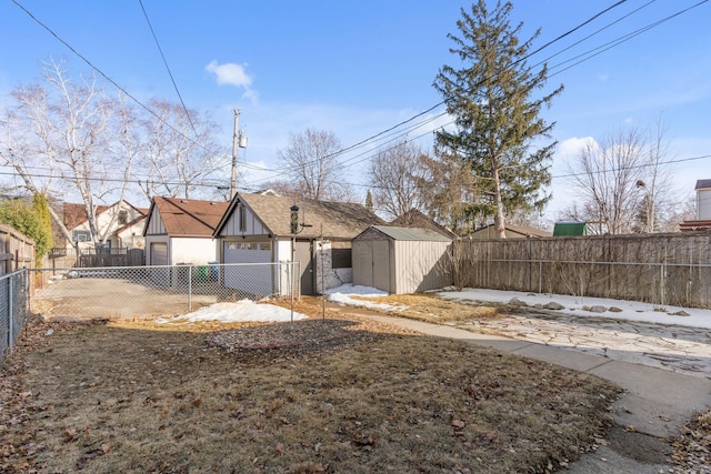 view of yard with a storage shed, an outbuilding, and a fenced backyard