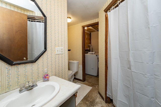 full bathroom with wallpapered walls, toilet, washer / clothes dryer, and vanity