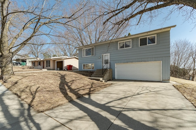 split foyer home featuring an attached garage and driveway