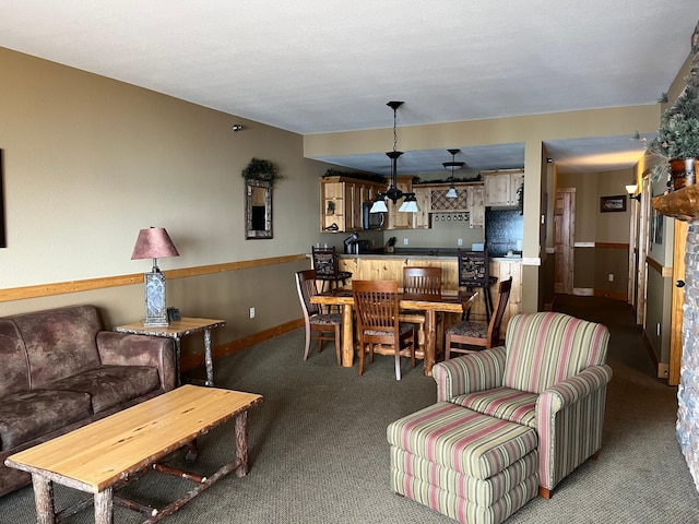 carpeted living room with baseboards