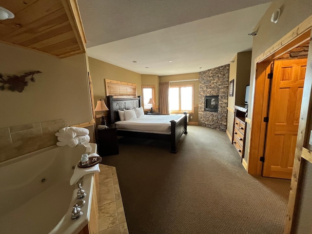 bedroom with a fireplace and carpet