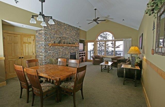 dining area featuring baseboards, carpet, a fireplace, high vaulted ceiling, and a ceiling fan