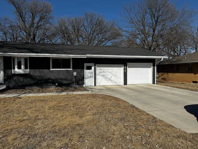 ranch-style home with an attached garage, concrete driveway, and a shingled roof