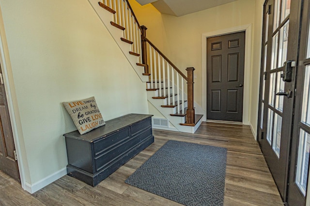 entryway with visible vents, baseboards, and wood finished floors