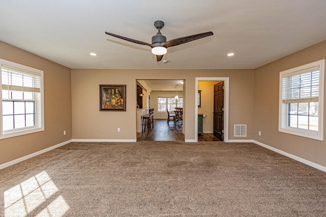 unfurnished living room featuring visible vents, recessed lighting, baseboards, and carpet