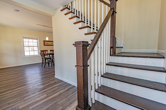 stairs with baseboards and wood finished floors