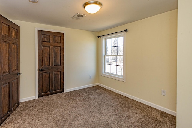 unfurnished bedroom featuring visible vents, baseboards, and carpet