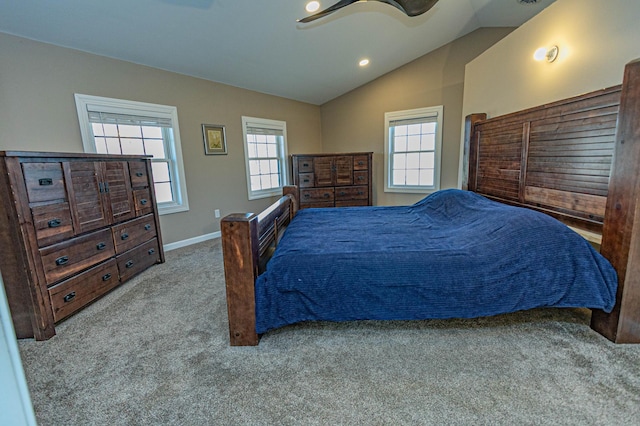 bedroom featuring multiple windows, carpet floors, a ceiling fan, and vaulted ceiling