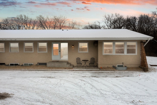 ranch-style house featuring brick siding