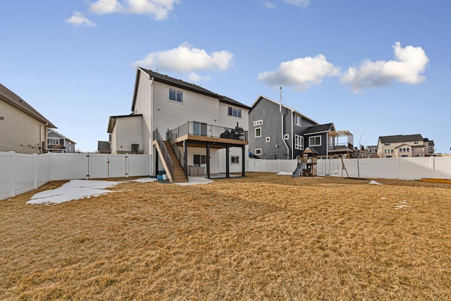 rear view of house featuring a fenced backyard, a playground, a patio, and a gate