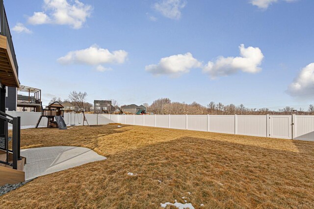 view of yard featuring a playground and a fenced backyard