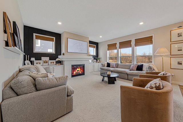 living area with recessed lighting, a healthy amount of sunlight, and carpet