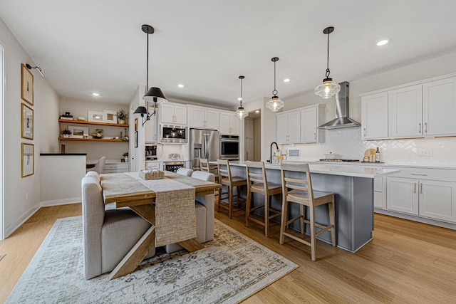 dining area featuring recessed lighting, light wood-type flooring, and baseboards