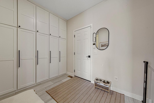 entrance foyer with light wood finished floors and baseboards