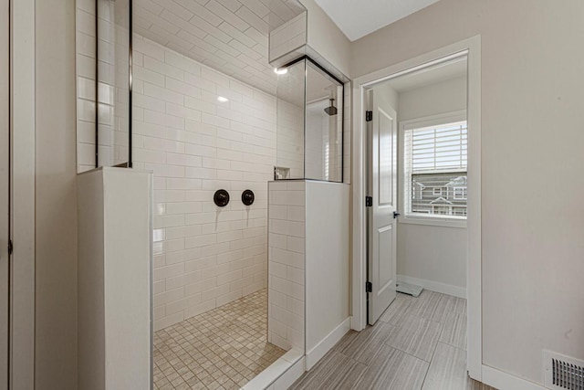 full bath with visible vents, a walk in shower, and baseboards