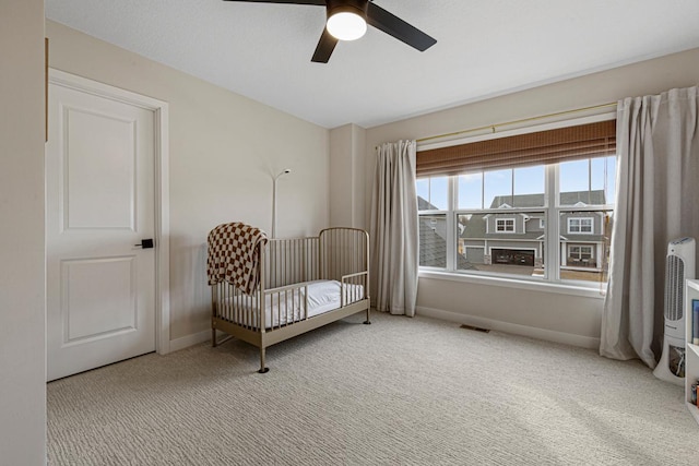 bedroom featuring a ceiling fan, baseboards, visible vents, and carpet floors