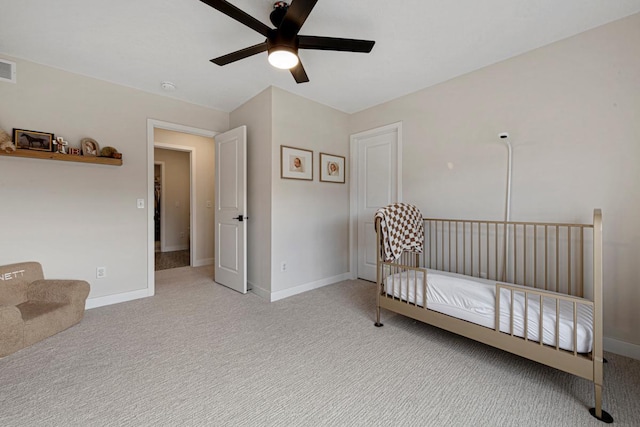 carpeted bedroom featuring visible vents, baseboards, and a ceiling fan