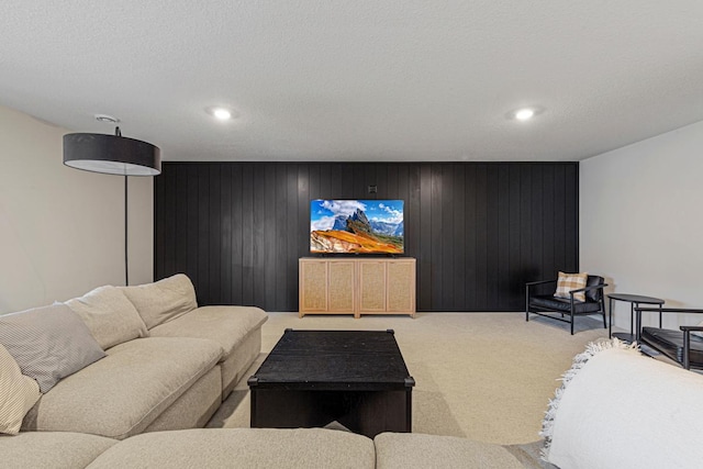 living room with recessed lighting, light colored carpet, and a textured ceiling