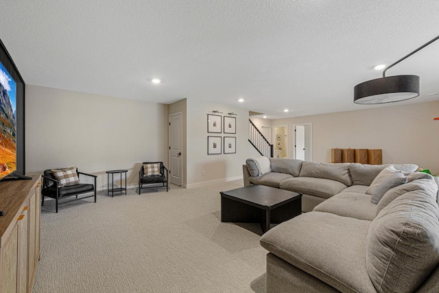 living area with light carpet, a textured ceiling, recessed lighting, baseboards, and stairs