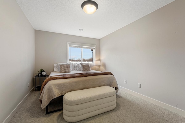 bedroom with baseboards, a textured ceiling, and carpet flooring