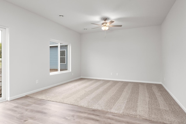 spare room with wood finished floors, baseboards, and ceiling fan