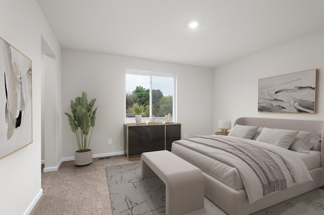 bedroom with light colored carpet and baseboards