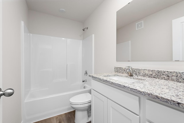 bathroom with visible vents, tub / shower combination, toilet, wood finished floors, and vanity