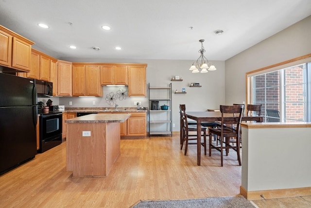 kitchen with recessed lighting, black appliances, light wood-style floors, a notable chandelier, and a center island