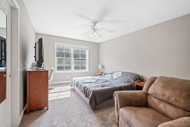 bedroom with a ceiling fan, light colored carpet, and baseboards