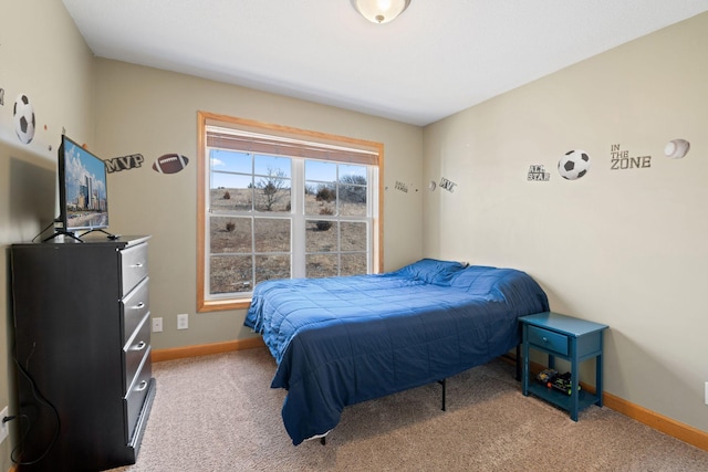 bedroom featuring baseboards and light colored carpet