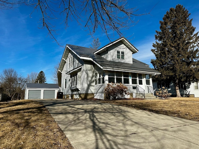 view of front facade featuring a garage and an outbuilding