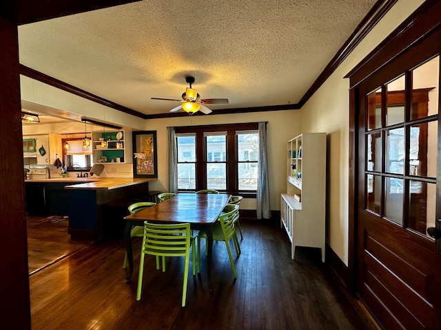 dining area featuring dark wood-style floors, a textured ceiling, and ornamental molding