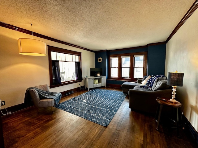 living area with wood-type flooring, a healthy amount of sunlight, and crown molding