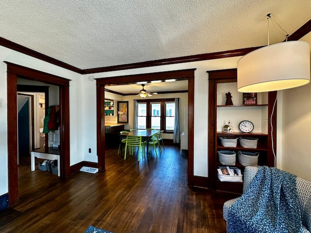 interior space featuring dark wood-style floors, baseboards, french doors, a textured ceiling, and crown molding