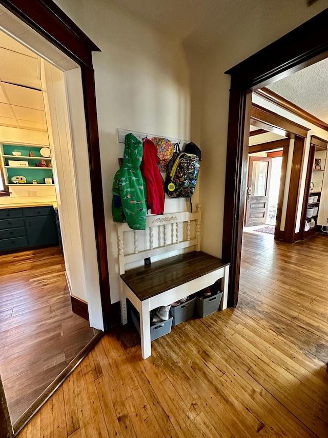 mudroom featuring wood-type flooring and ornamental molding