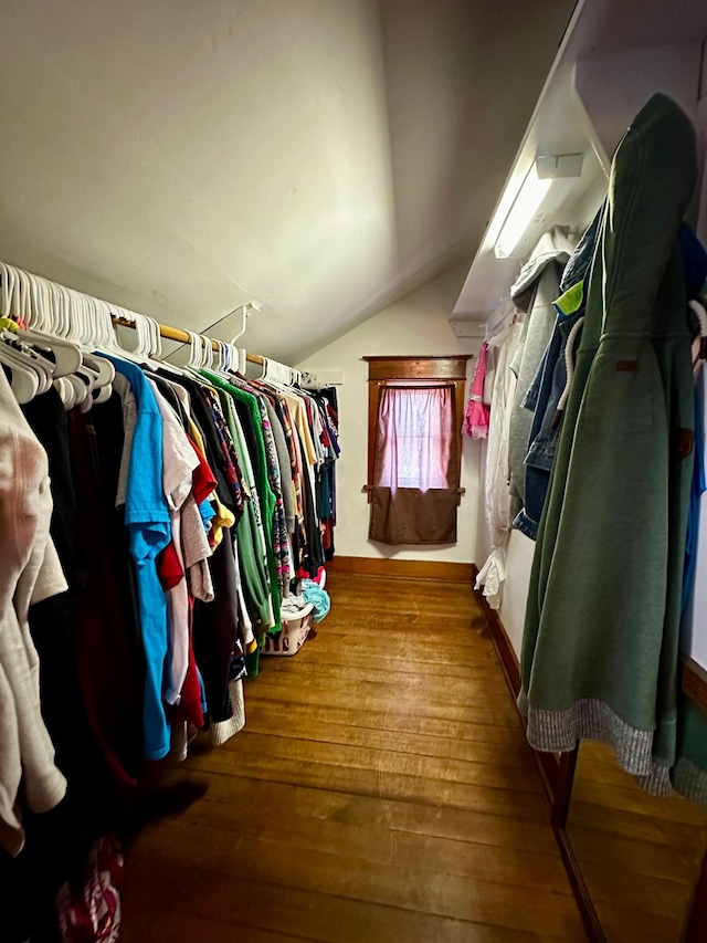 spacious closet with vaulted ceiling and wood finished floors