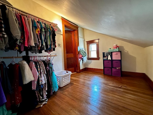 spacious closet with hardwood / wood-style flooring and vaulted ceiling