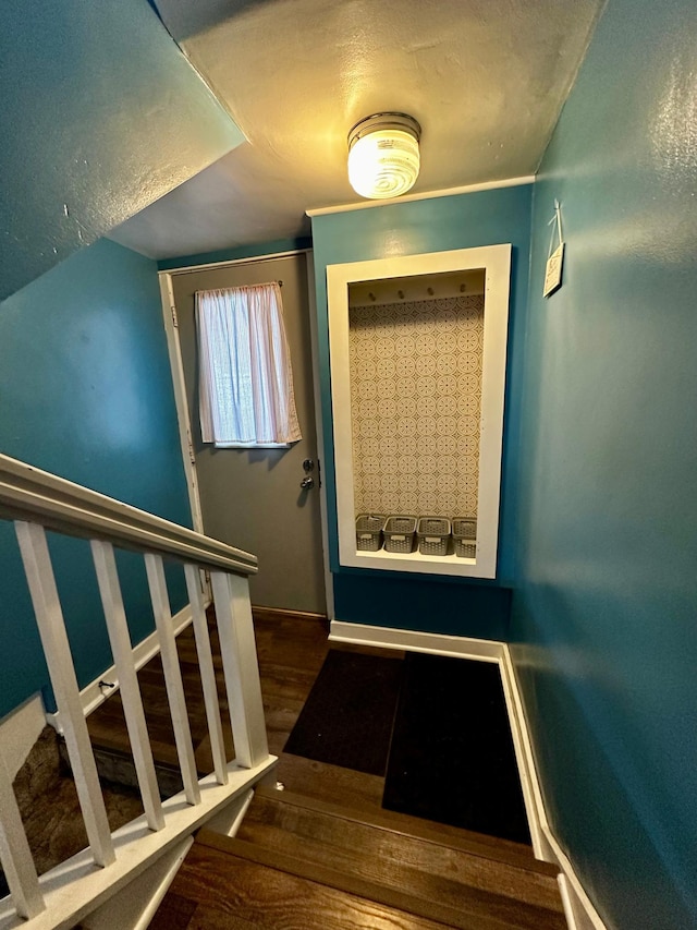 stairs featuring wood finished floors and baseboards