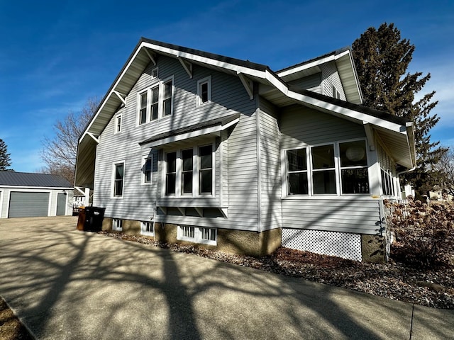 view of side of property with a garage and an outdoor structure