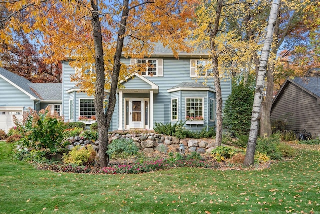 view of front of house with a front lawn and an attached garage